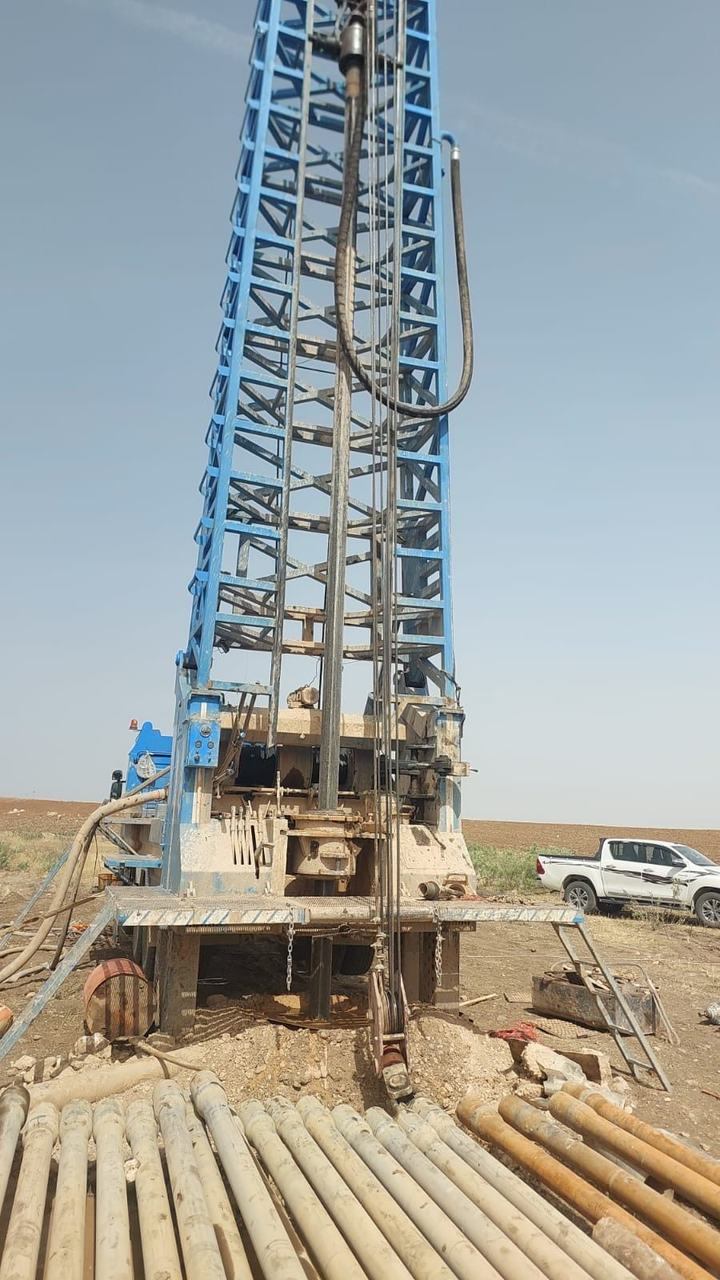 Workers installing pipe in a trench