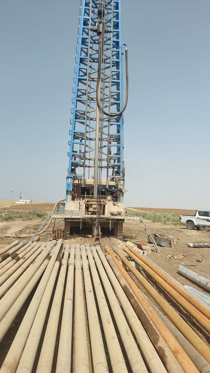 Workers installing pipe in a trench