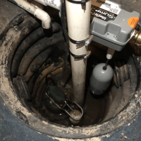 Efficient sump pump system installed in a residential basement - safeguard against water damage.