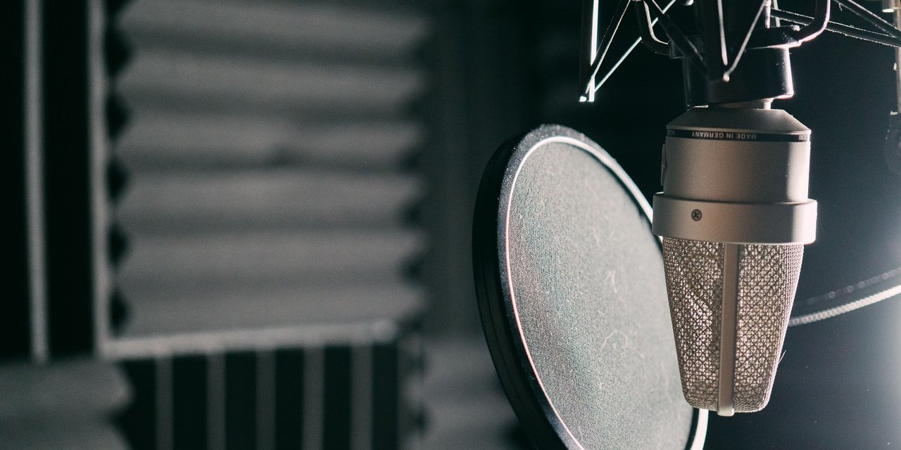 Close-up of a studio microphone with a pop filter
