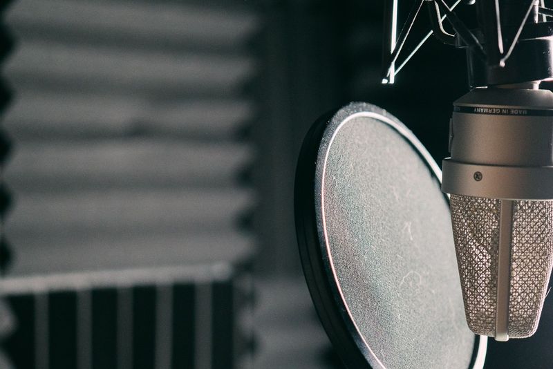 Close-up of a studio microphone with a pop filter