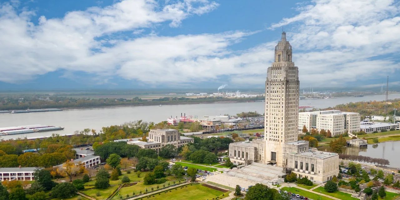 Aerial view of the Louisiana State Capitol tower in Baton Rouge, with the Mississippi River behind