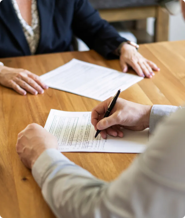 A person signing a contract.