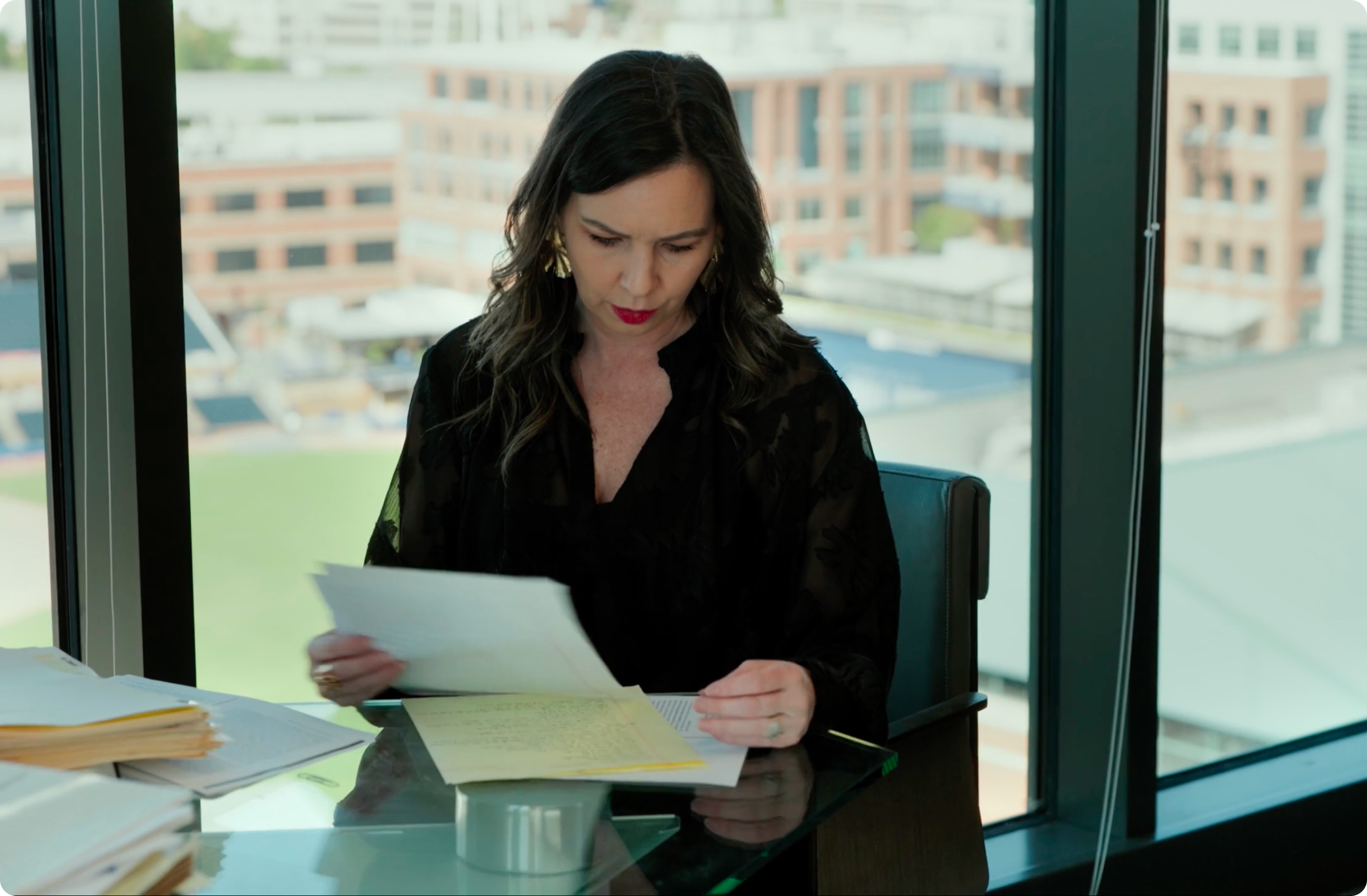 Woman looking through papers at a desk