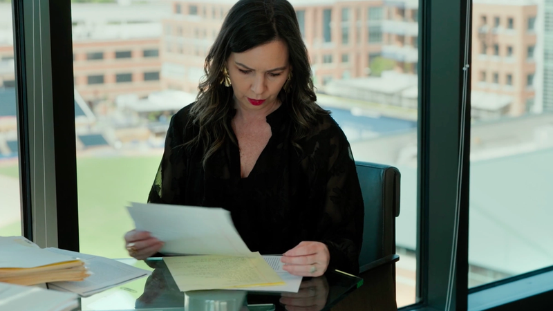 Woman looking through papers at a desk