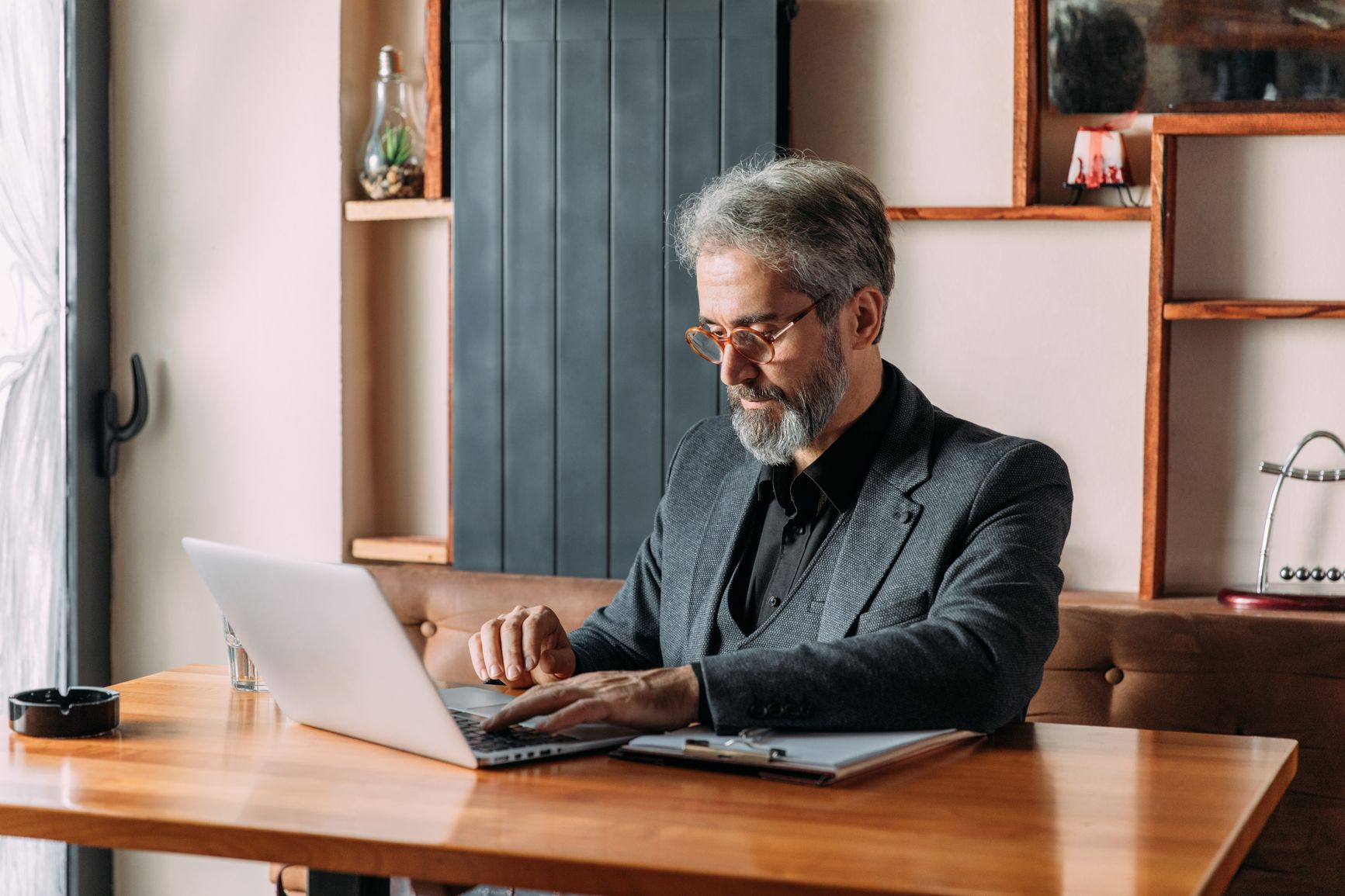Man at desk typing on laptop