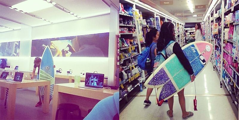 A surfboard leans against a table in an electronics store, and a person carries a surfboard down a pharmacy aisle.