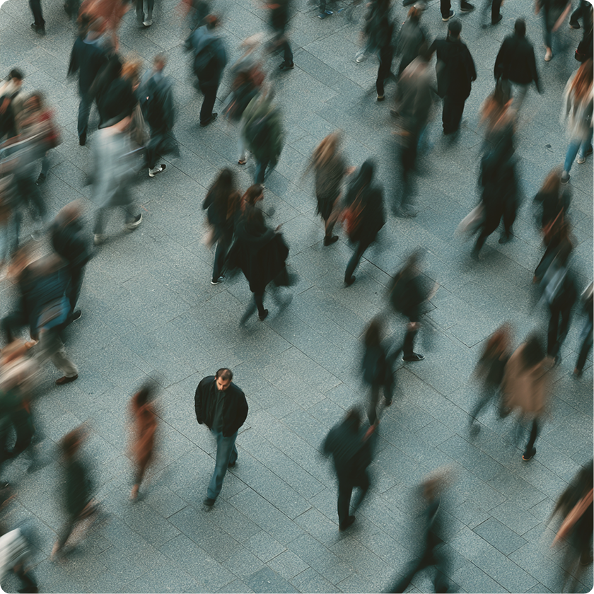 Overhead view of a crowd of people walking across a plaza