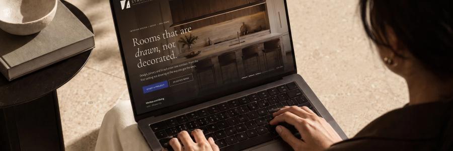 The Starsmen website open on a laptop on a pale desk.