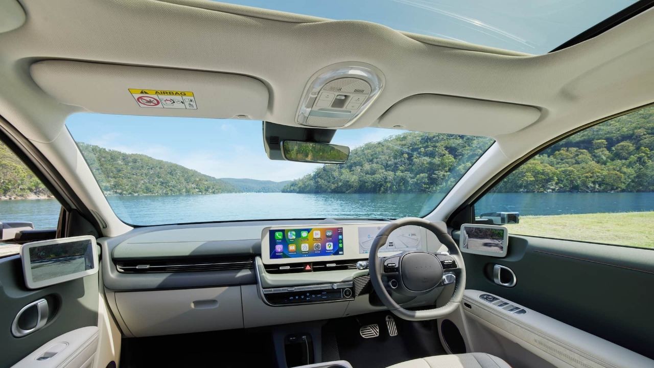 Light Brown Hyundai Ioniq 5 interior view right hand drive in front of lake