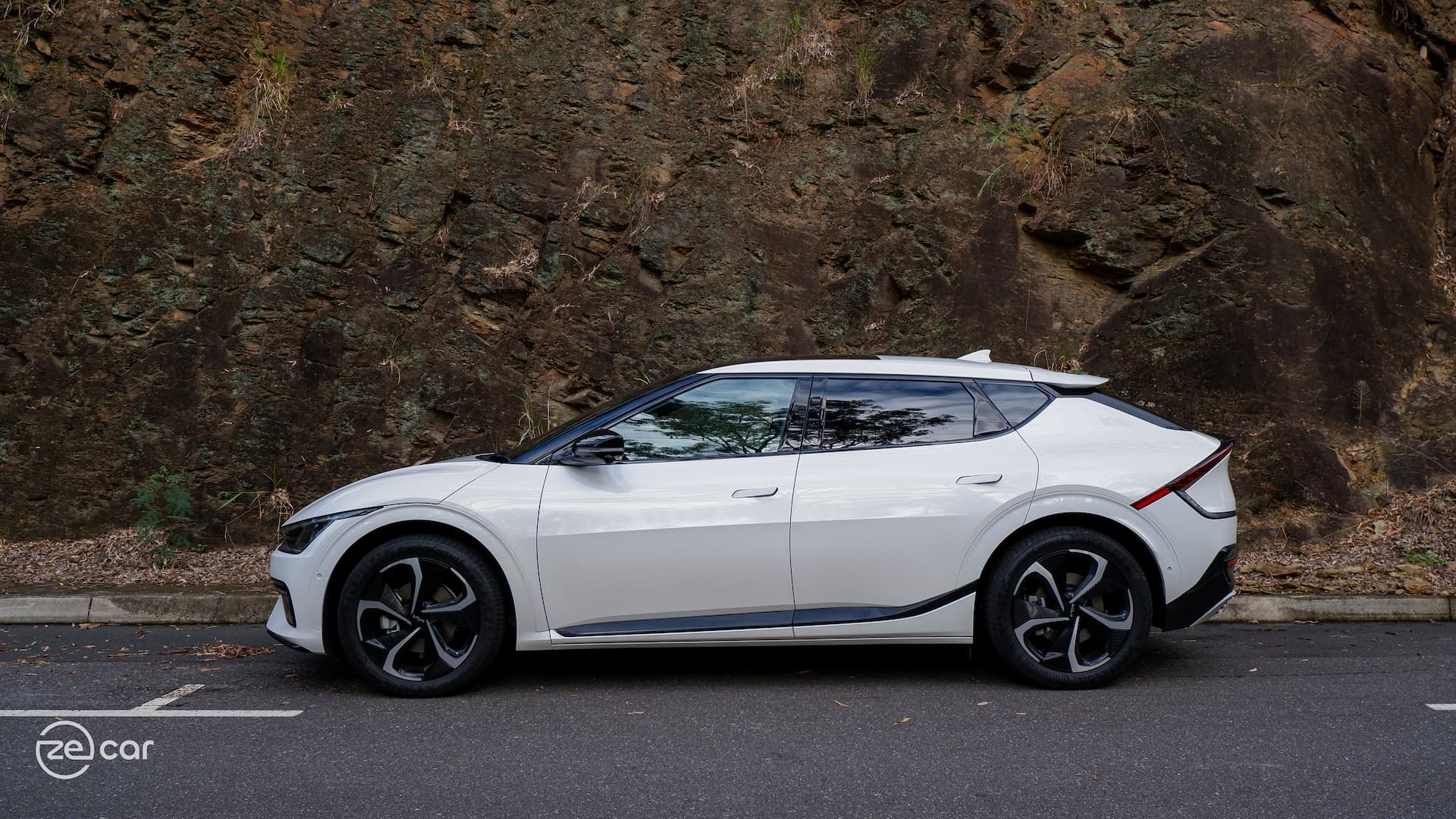 White Kia EV6 GT-Line on side of rocks