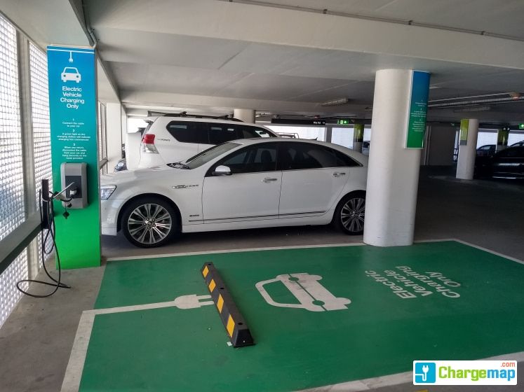 AC Charger in a carpark (left) and DC Fast Charger (right)