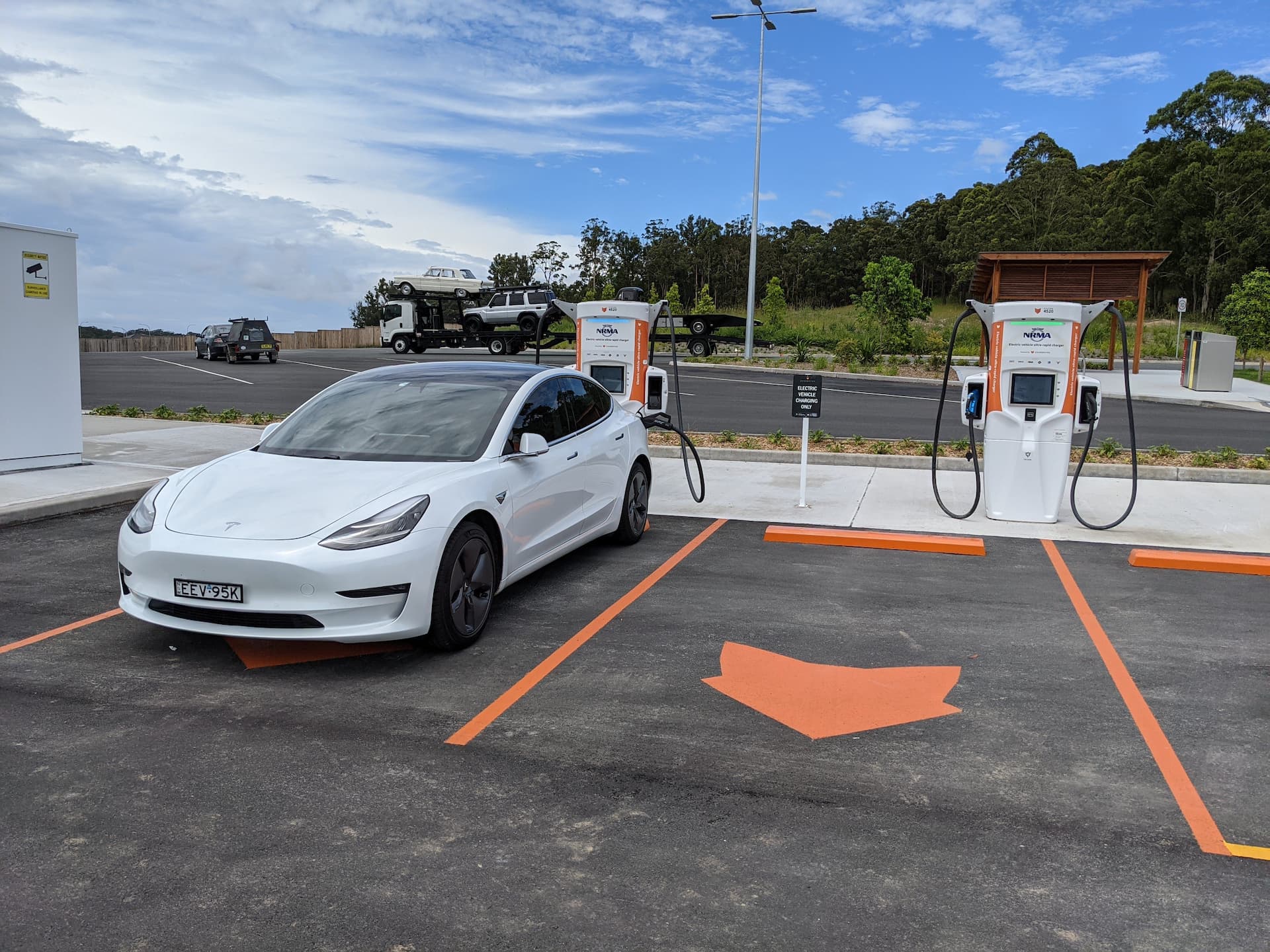 White Tesla Model 3 fast charging at Chargefox NRMA station