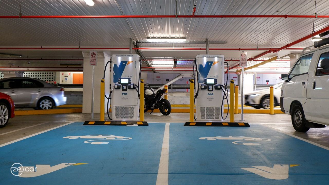 Cars drive pass Indooroopilly Shopping Centre Evie Networks Tritium EV chargers