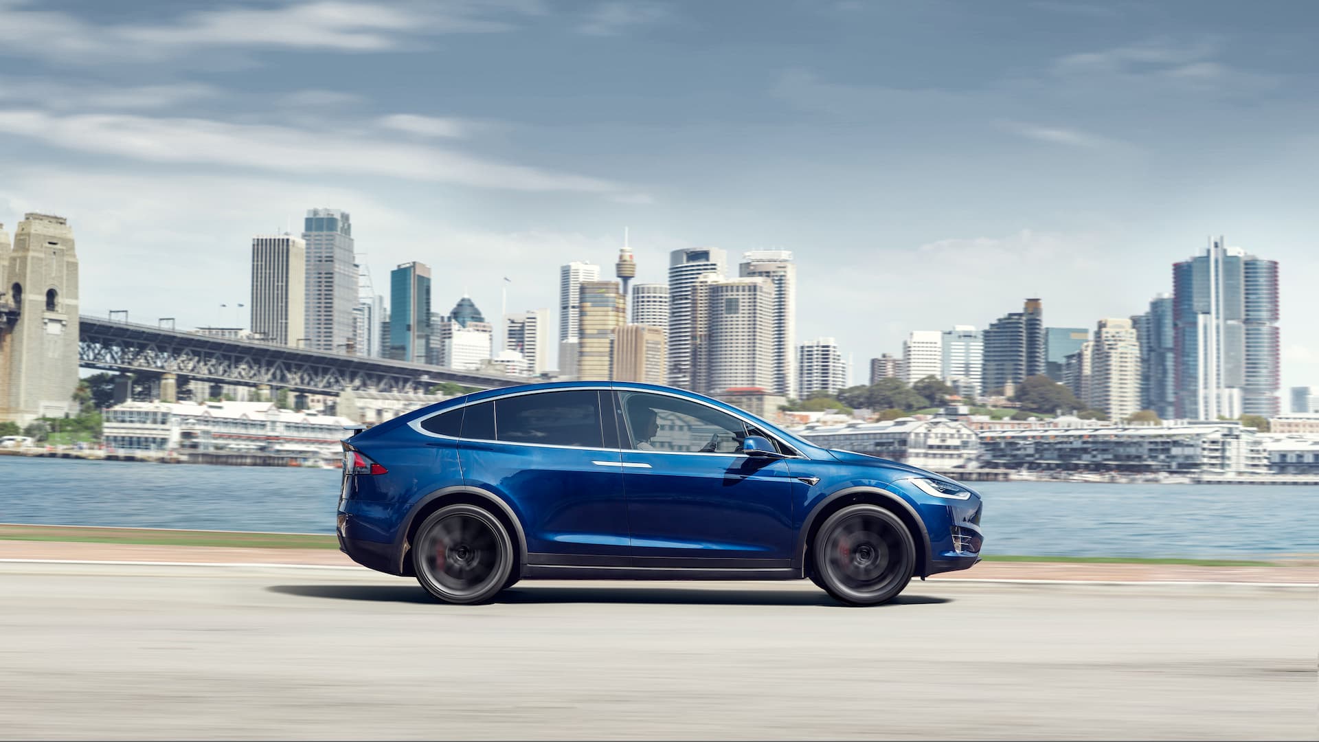 Blue Tesla Model X driving in Sydney