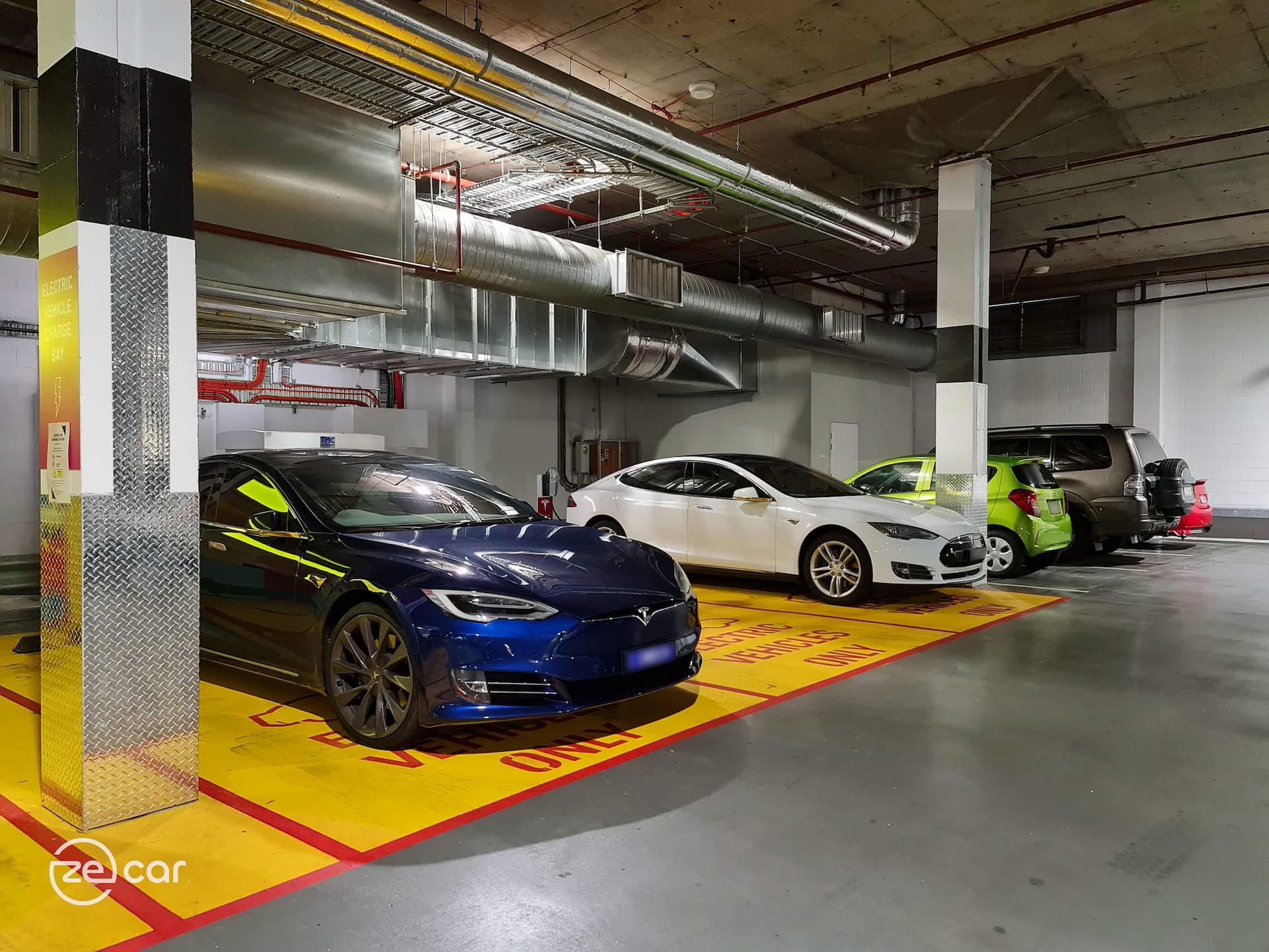 Blue Tesla Model S and white Tesla Model S Destination AC charging in carpark
