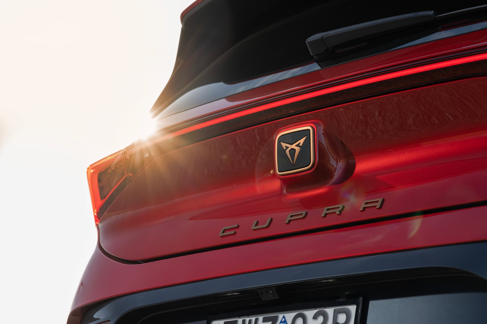Red Cupra Born driving and rear logo