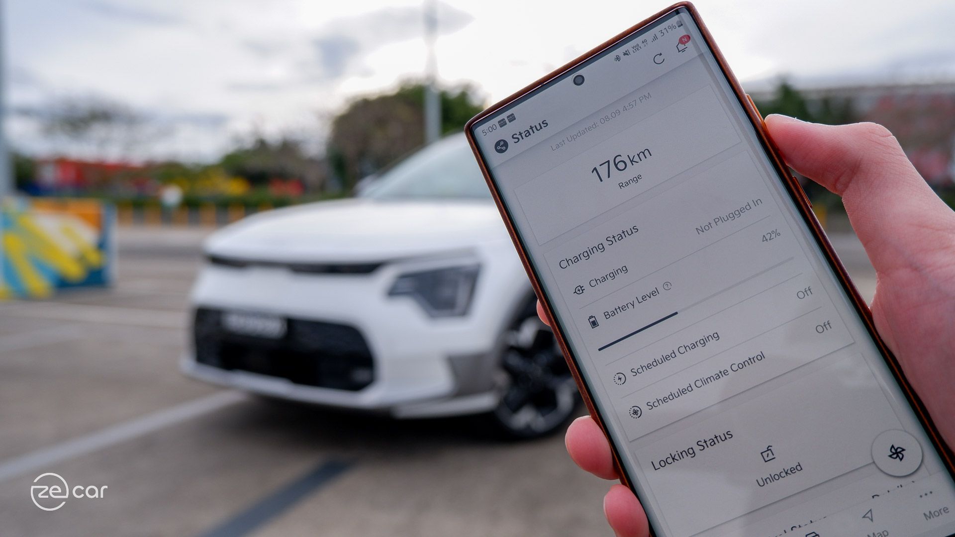 Kia Niro EV at charging station and mobile app