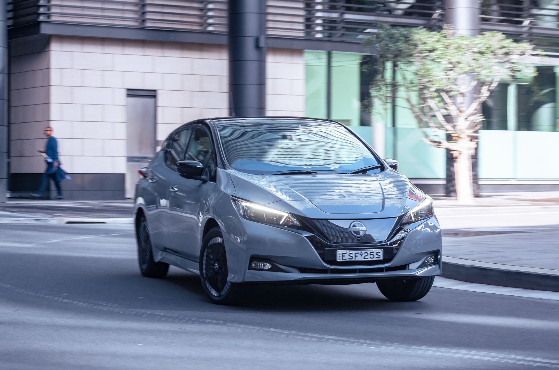 Grey 2023 Nissan Leaf driving in city