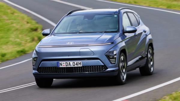 Hyundai KONA Electric exterior front three-quarter angle driving on road