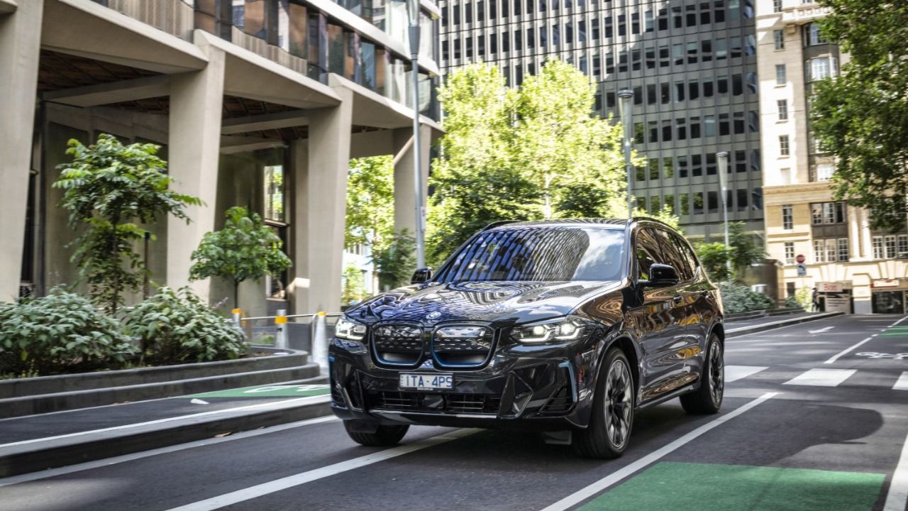 2024 BMW iX3 driving at city