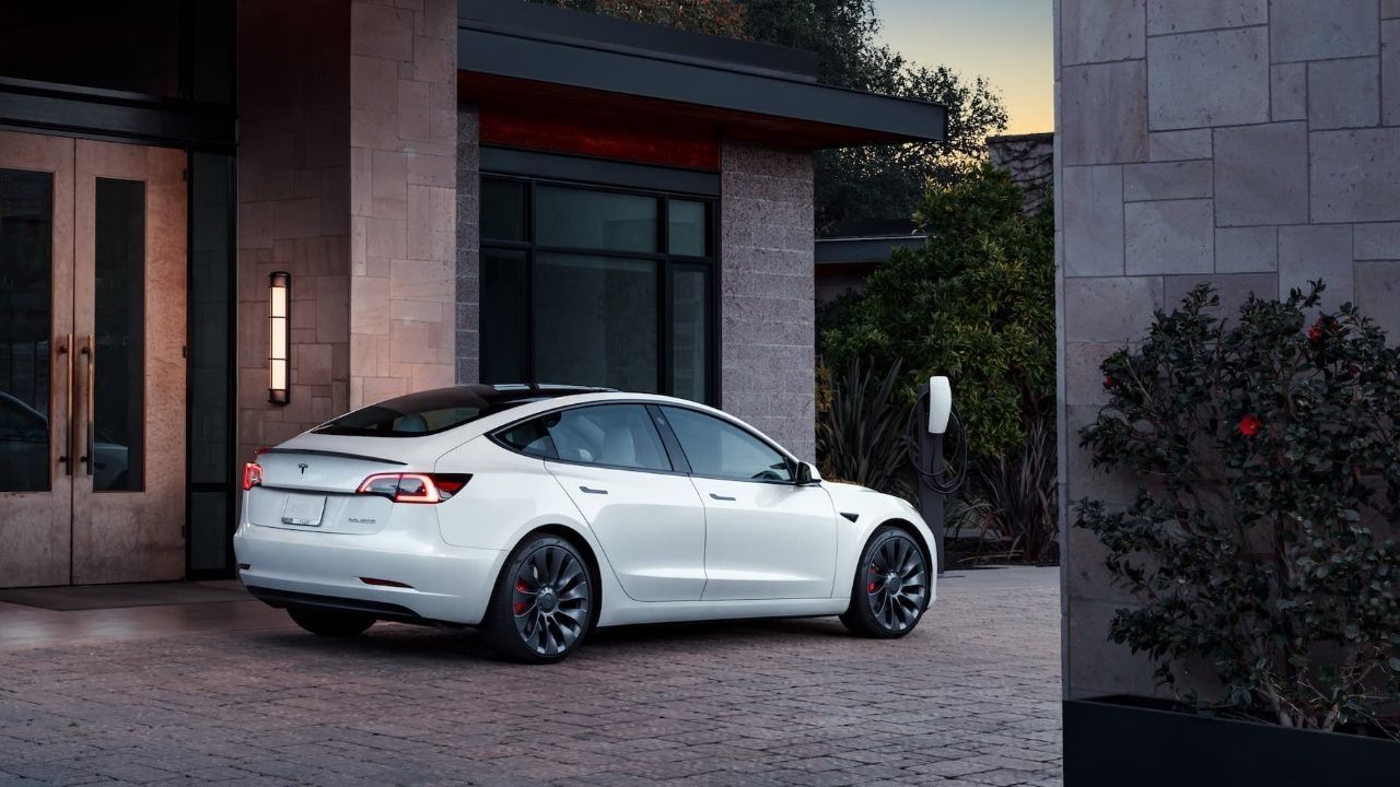 White Tesla Model 3 Performance rear in front of hotel