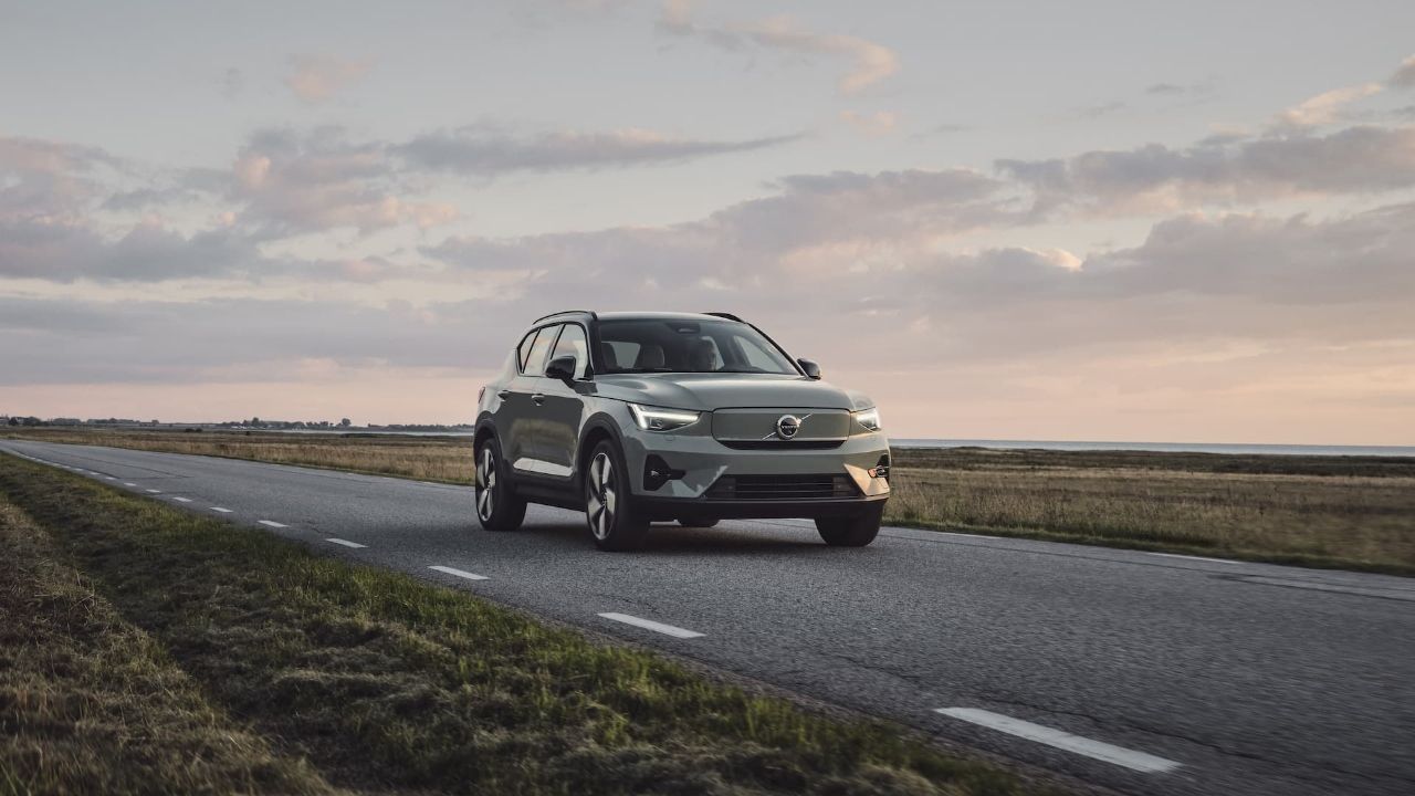 Green Volvo XC40 Recharge EV driving on road