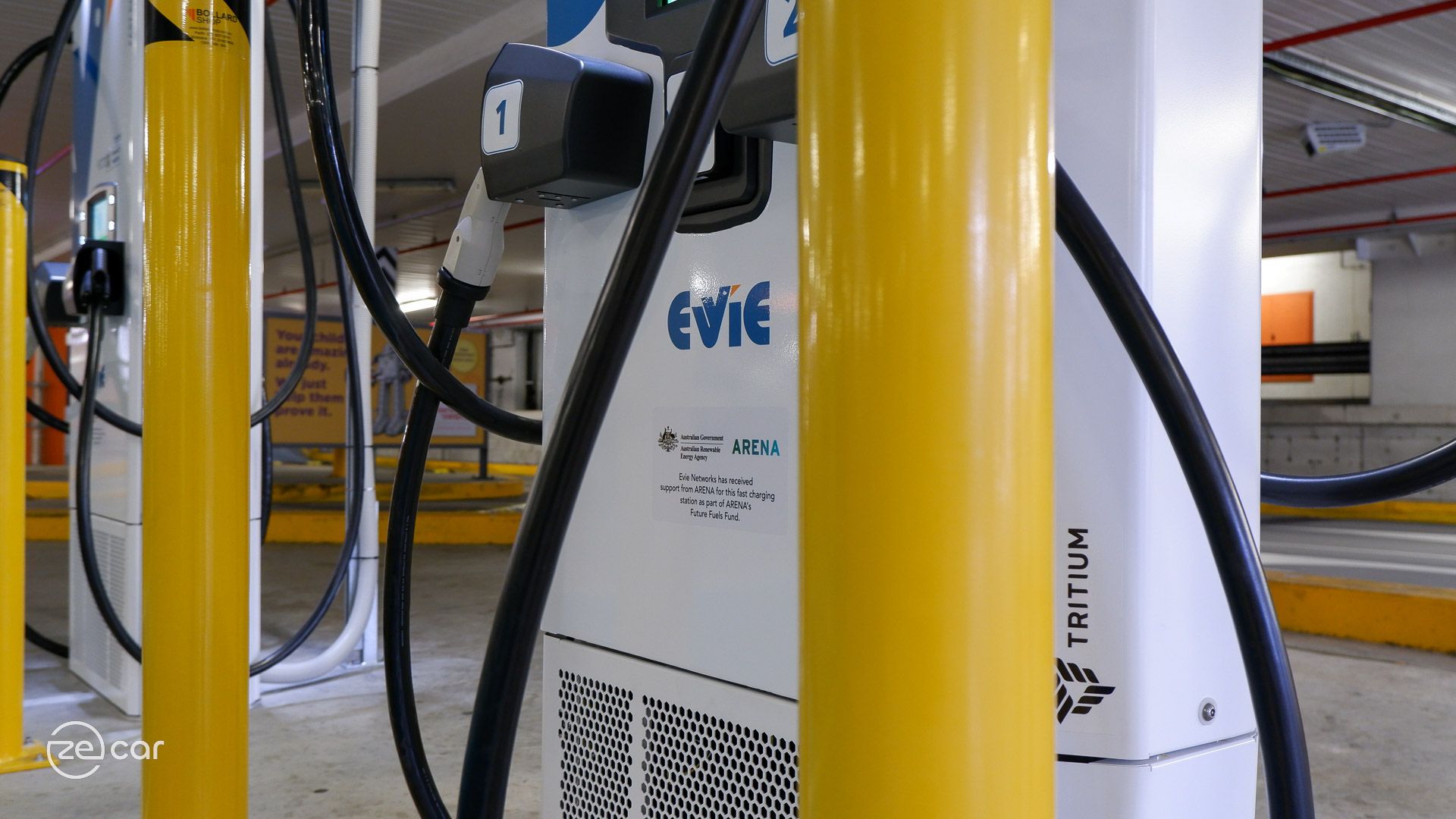 Evie Networks, Tritium and ARENA logos on EV charger
