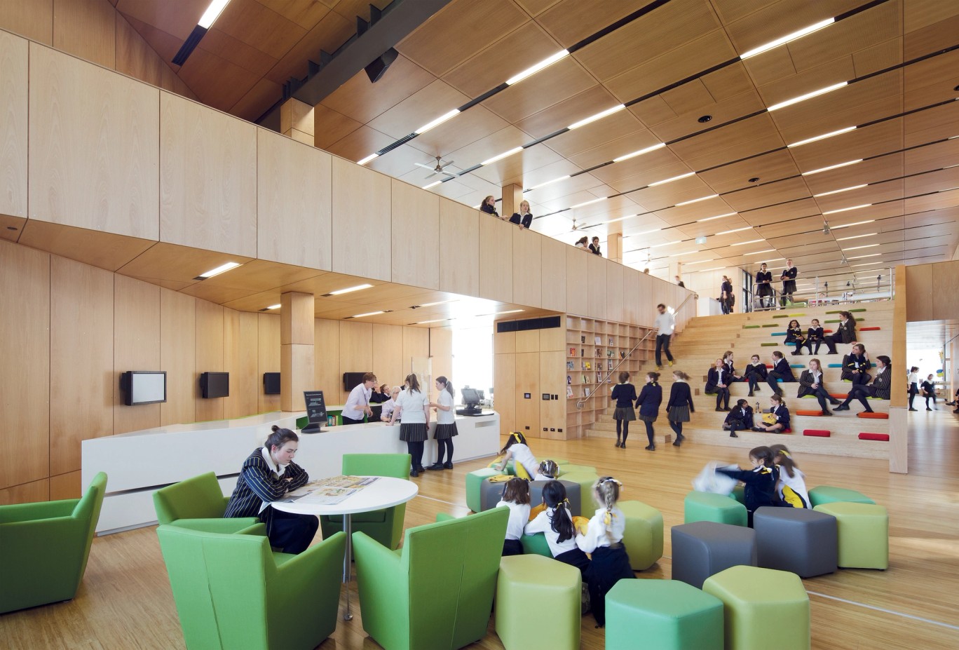 A wide central staircase connects the library with the classrooms on the lower levels. It doubles as a grandstand for students to sit and watch lectures and presentations.