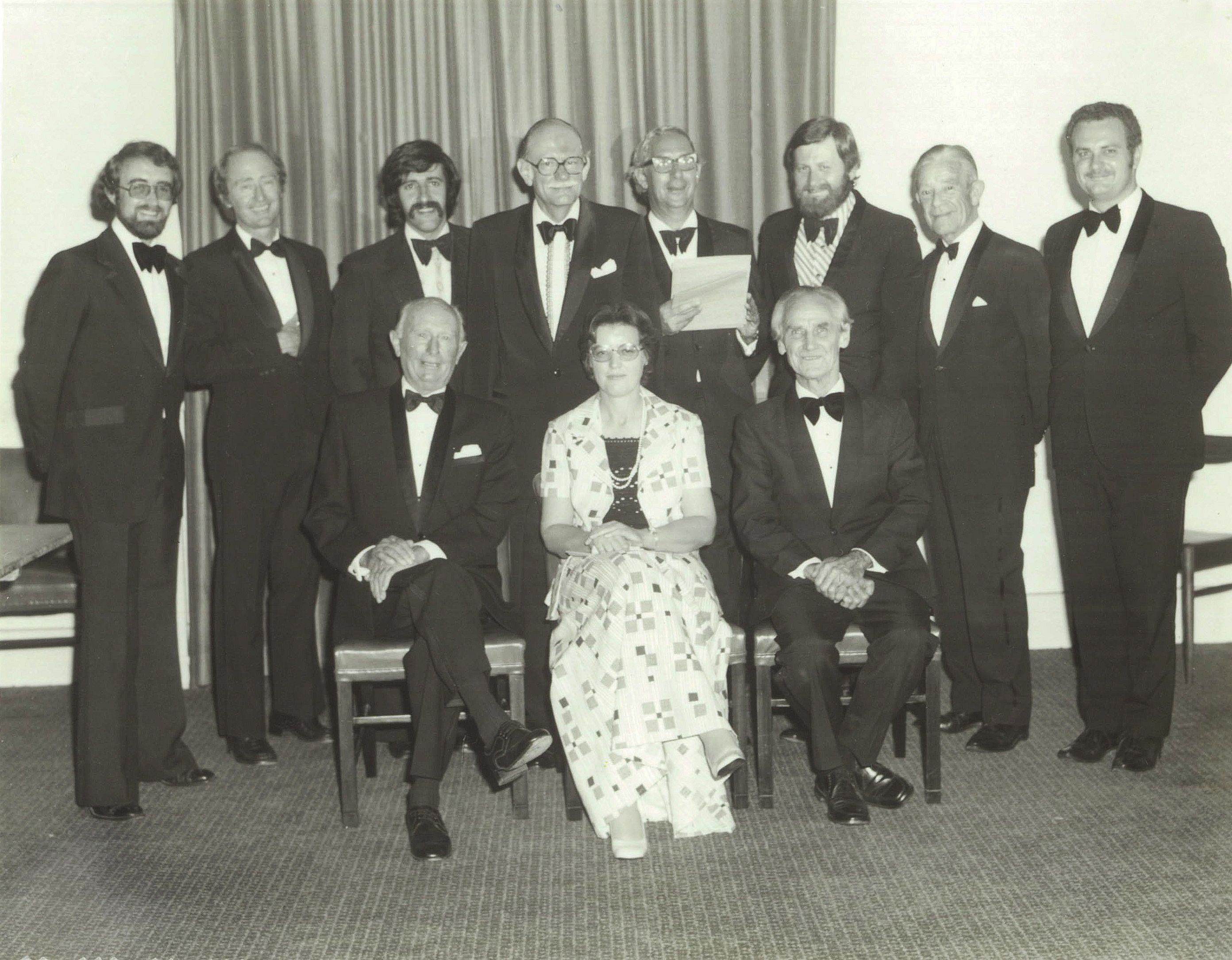 Arthur Bligh Retirement Dinner, 1975 Back row (L–R): Bruce Buchanan, Graham Bligh, Vic Feros, Ronald J. Voller, Bernard Ryan, Jon Voller, Athol Bretnall, Jim Fuller; Front row (L–R): Arthur Bligh, Helen Mills, Colin Jessup