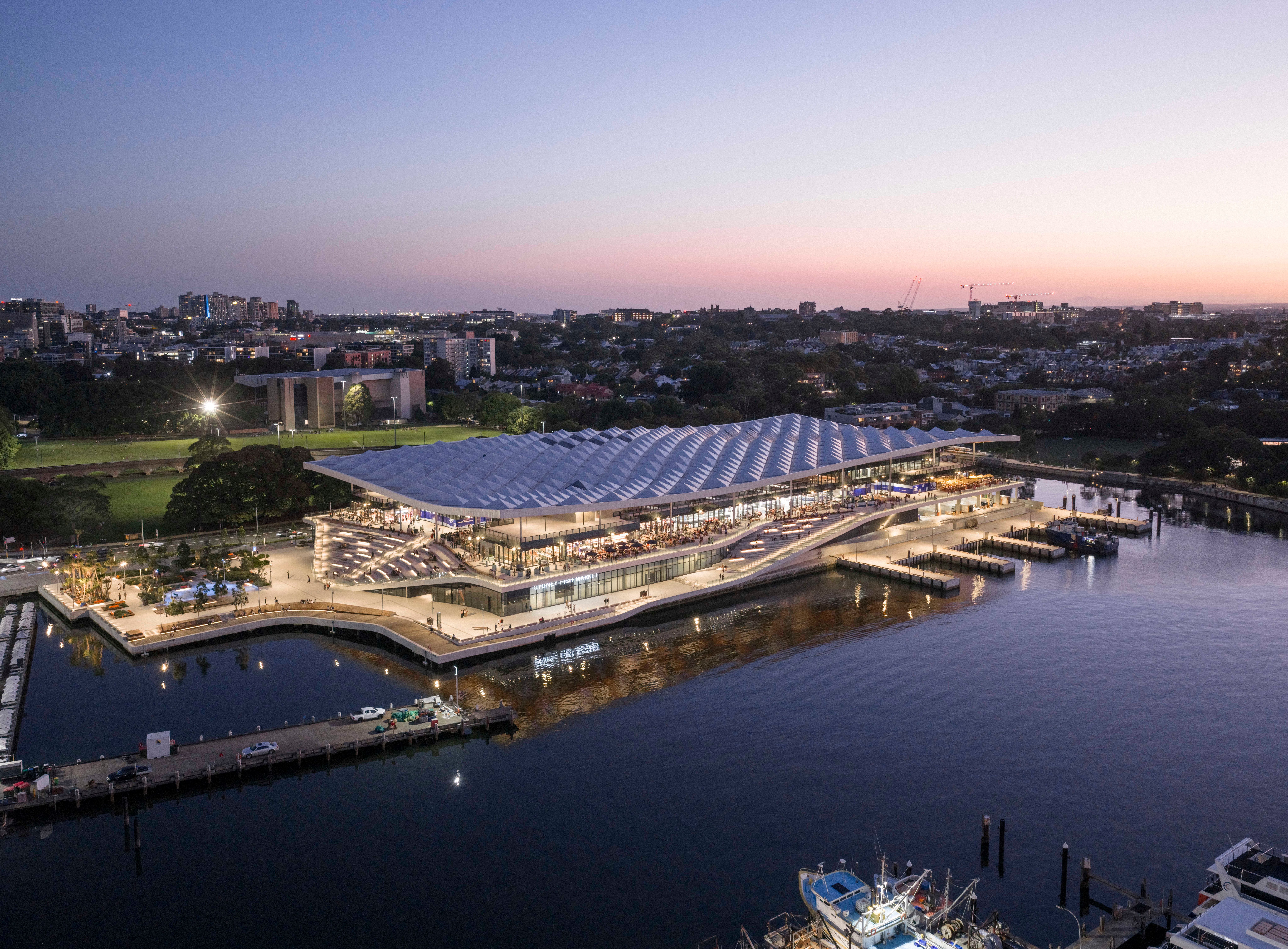 BVN Architecture Sydney civic architecture — New Sydney Fish Market waterfront public building at dusk, award-winning design