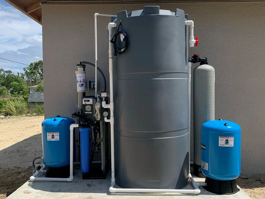 Reverse osmosis system, storage tank and blue pressure tanks installed on a concrete pad
