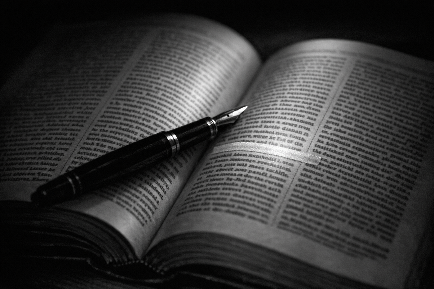 An open California statute book with one line of the printed text marked by a highlighter, beside a fountain pen.