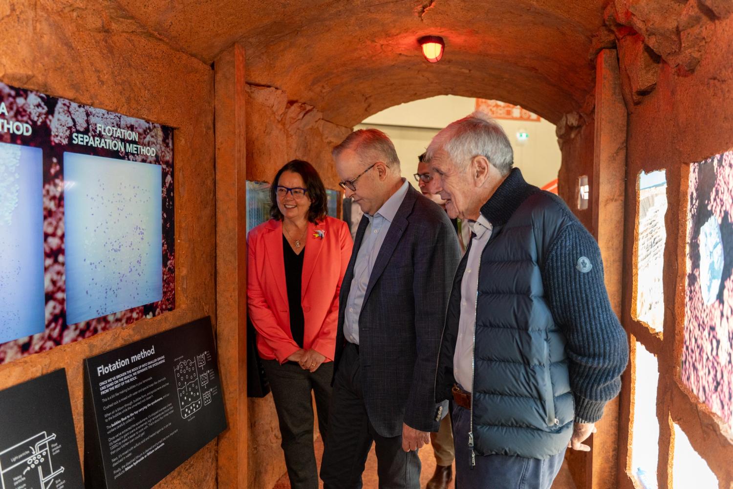 Three people looking at a screen