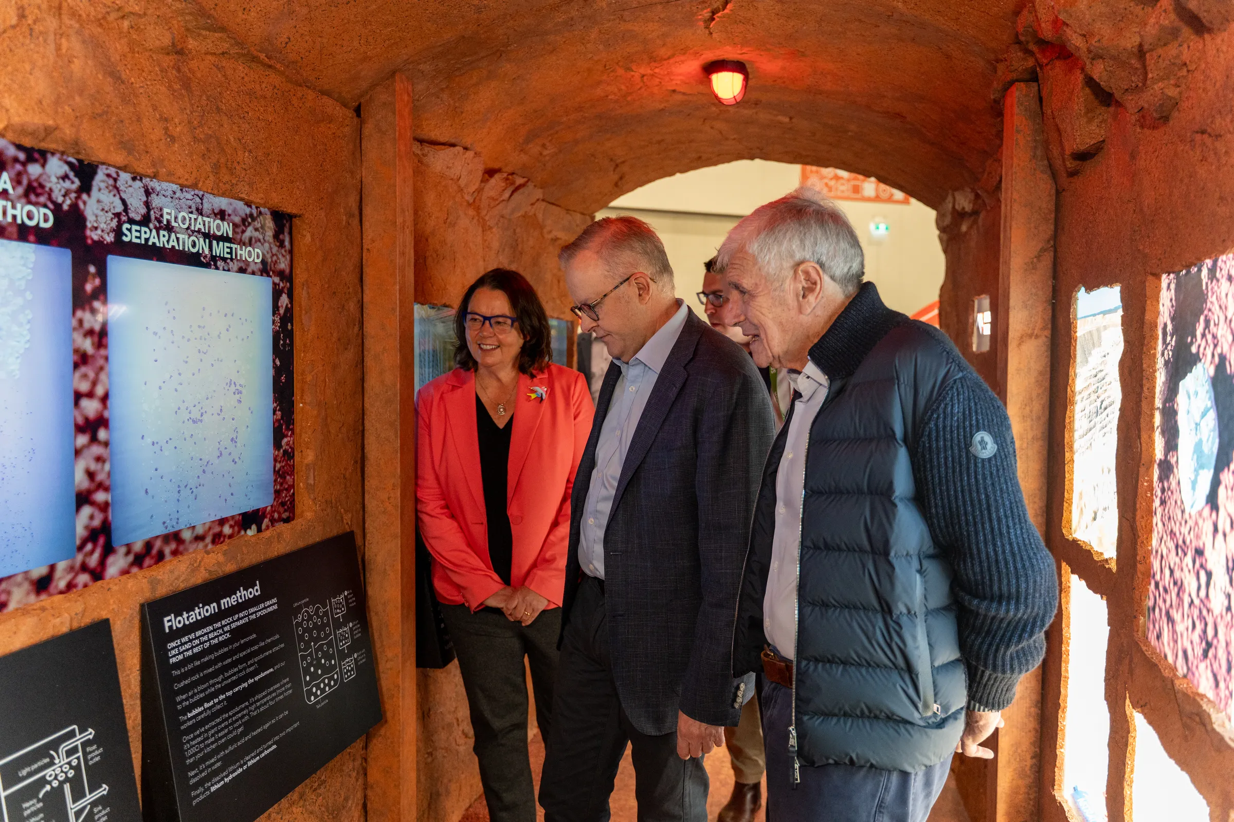 Three people looking at a screen