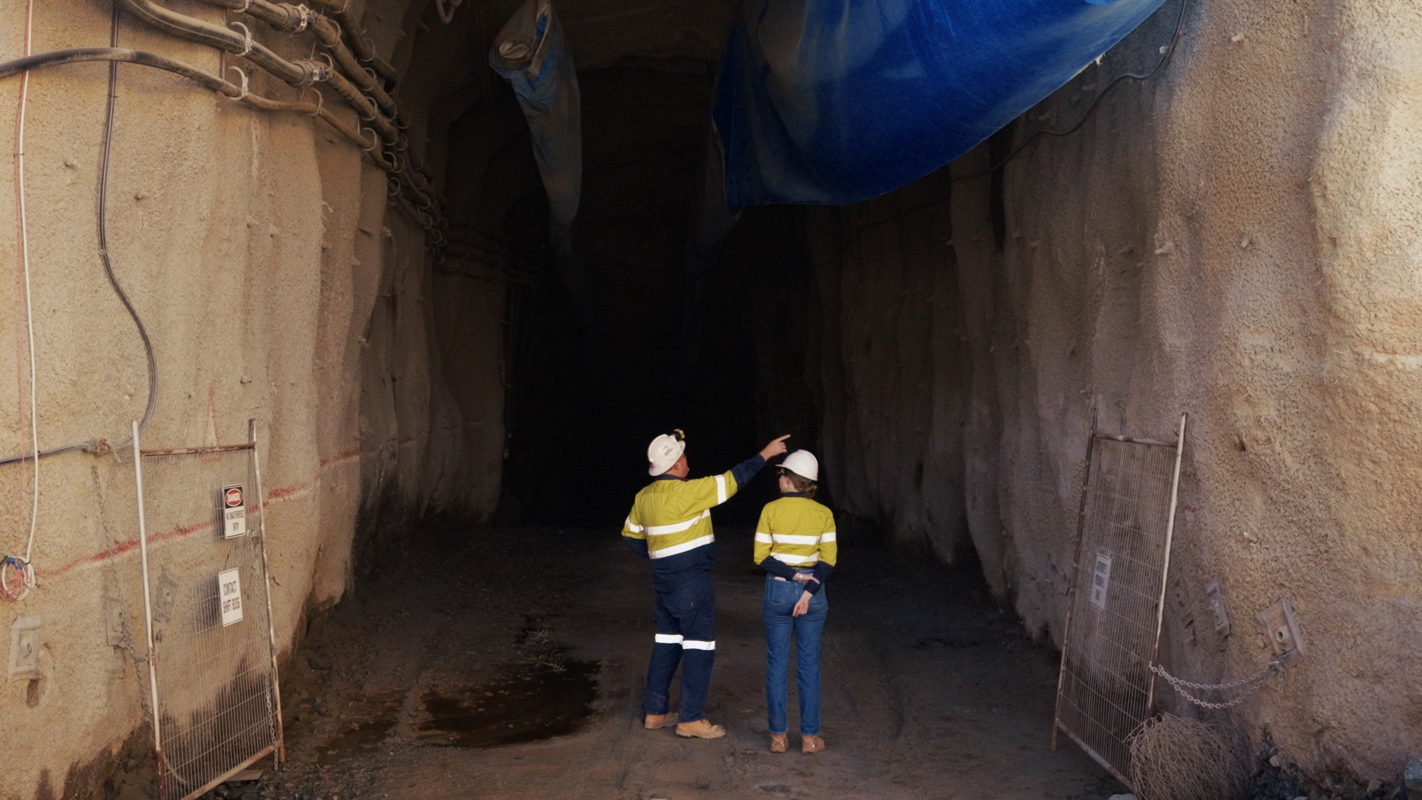 Two people standing in an underground mine