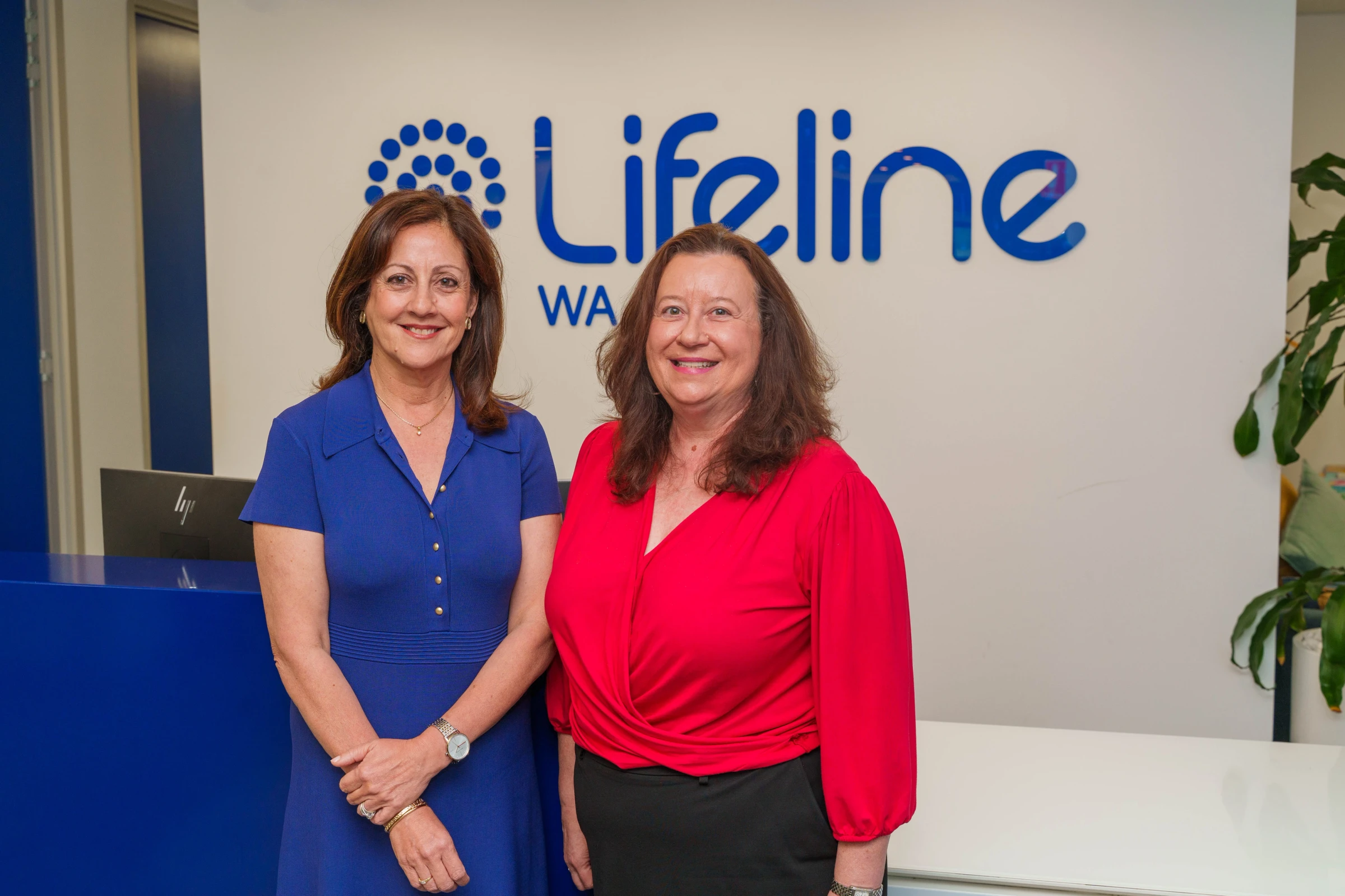 two women in front of lifeline sign