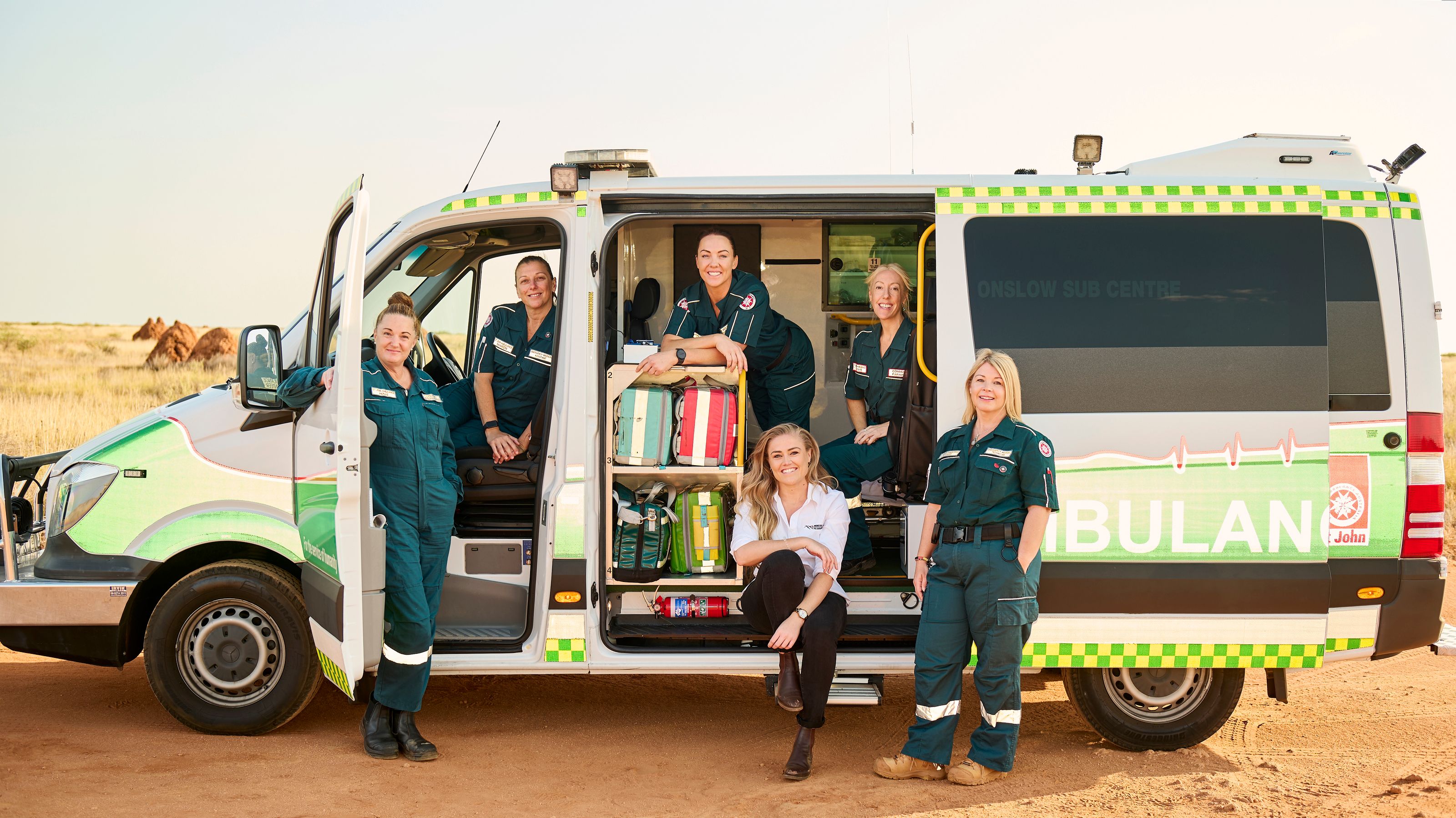 People standing on the side of an ambulance