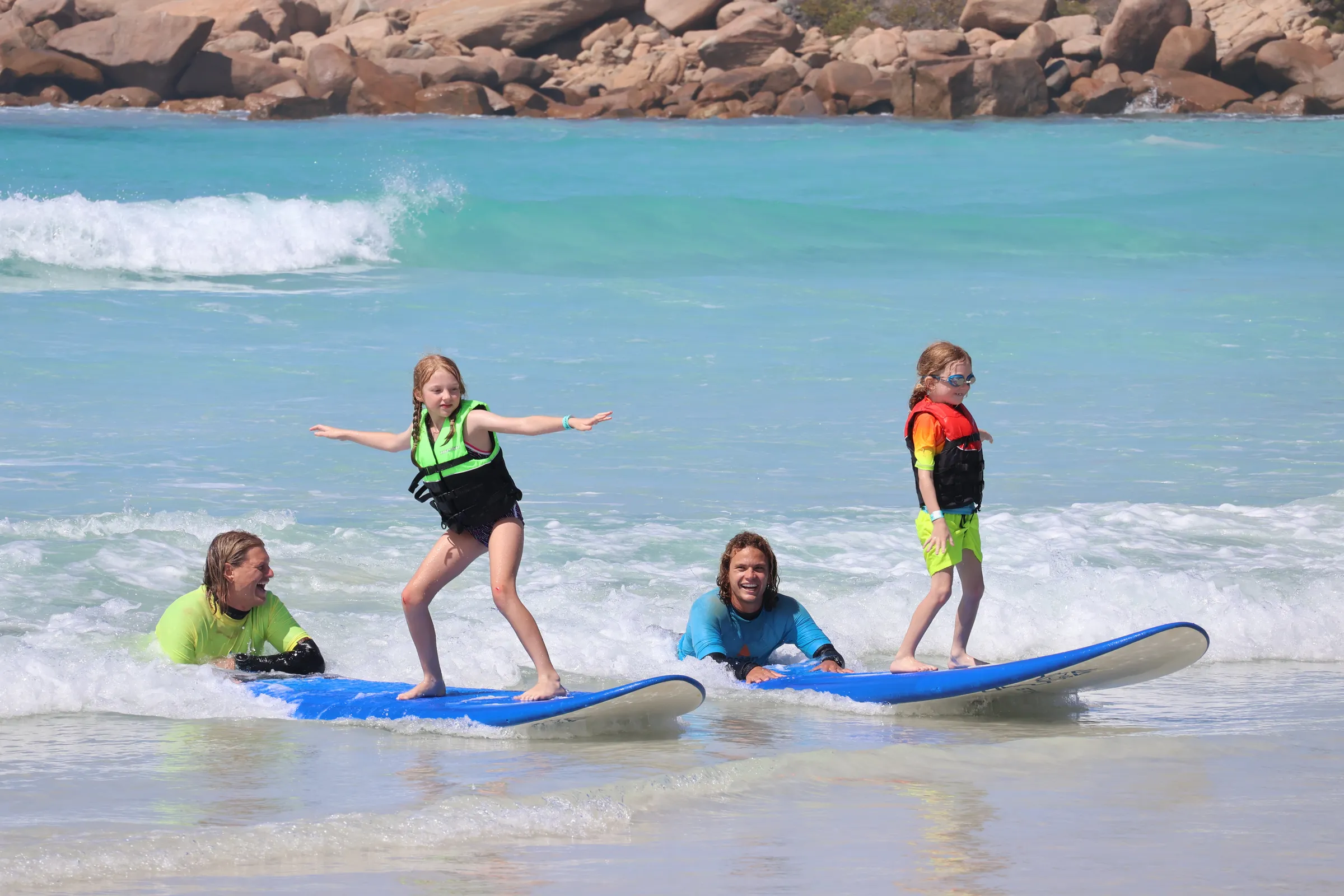 Children on stand up paddle boards in the ocean
