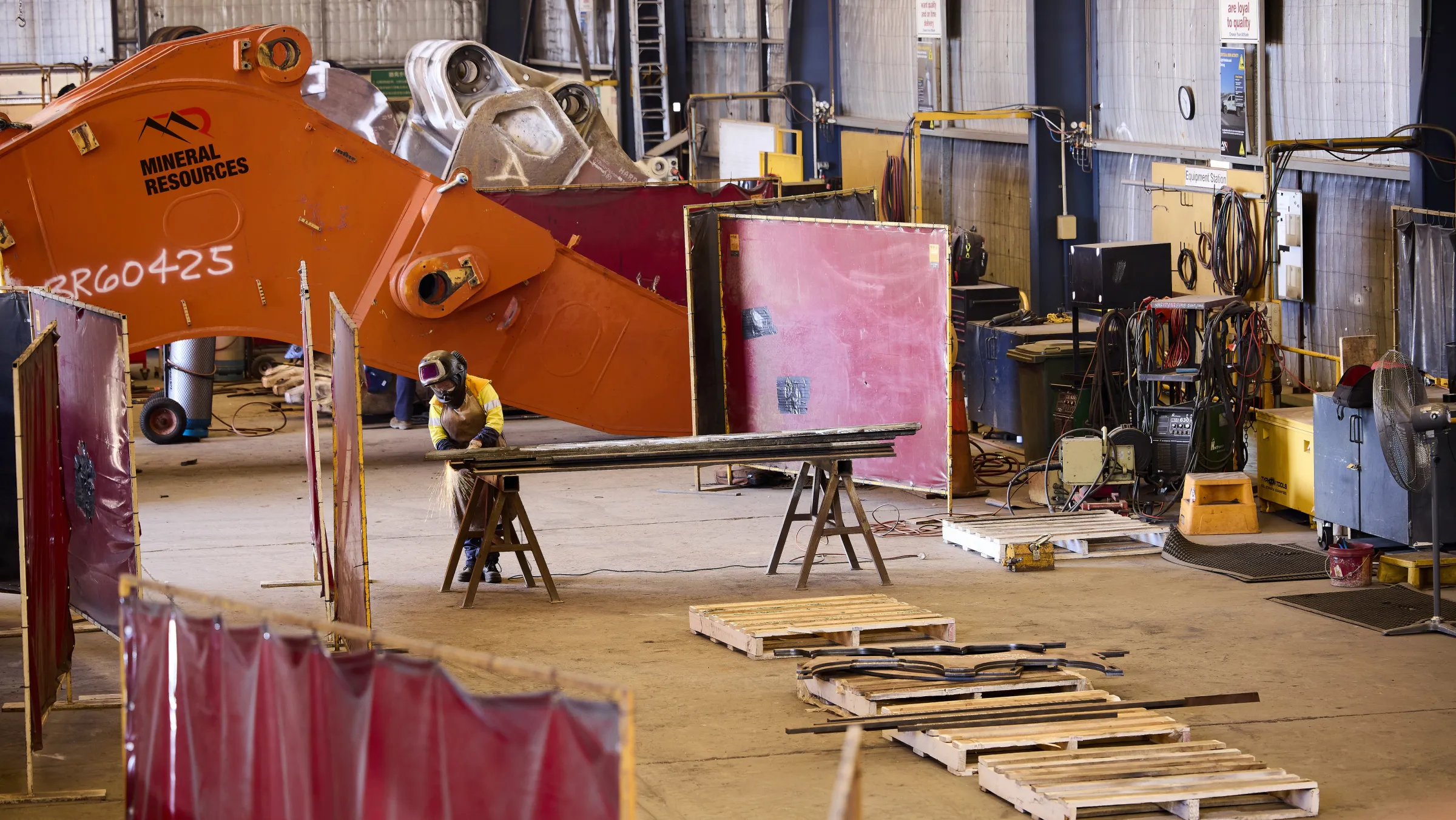 Woman (Mikayla) working on a piece of machinery in the workshop