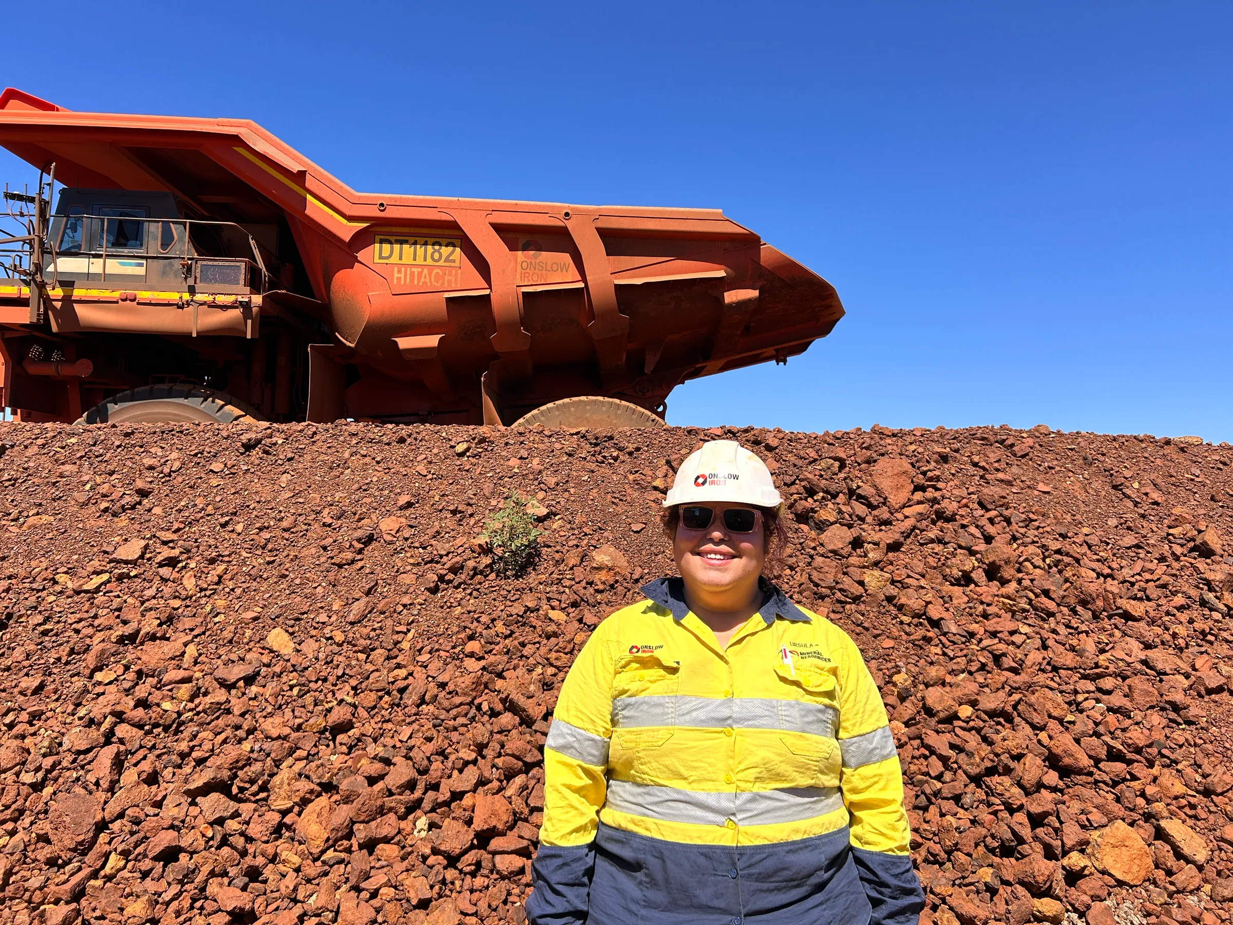 Ursula Lyndon standing in front of a dump truck