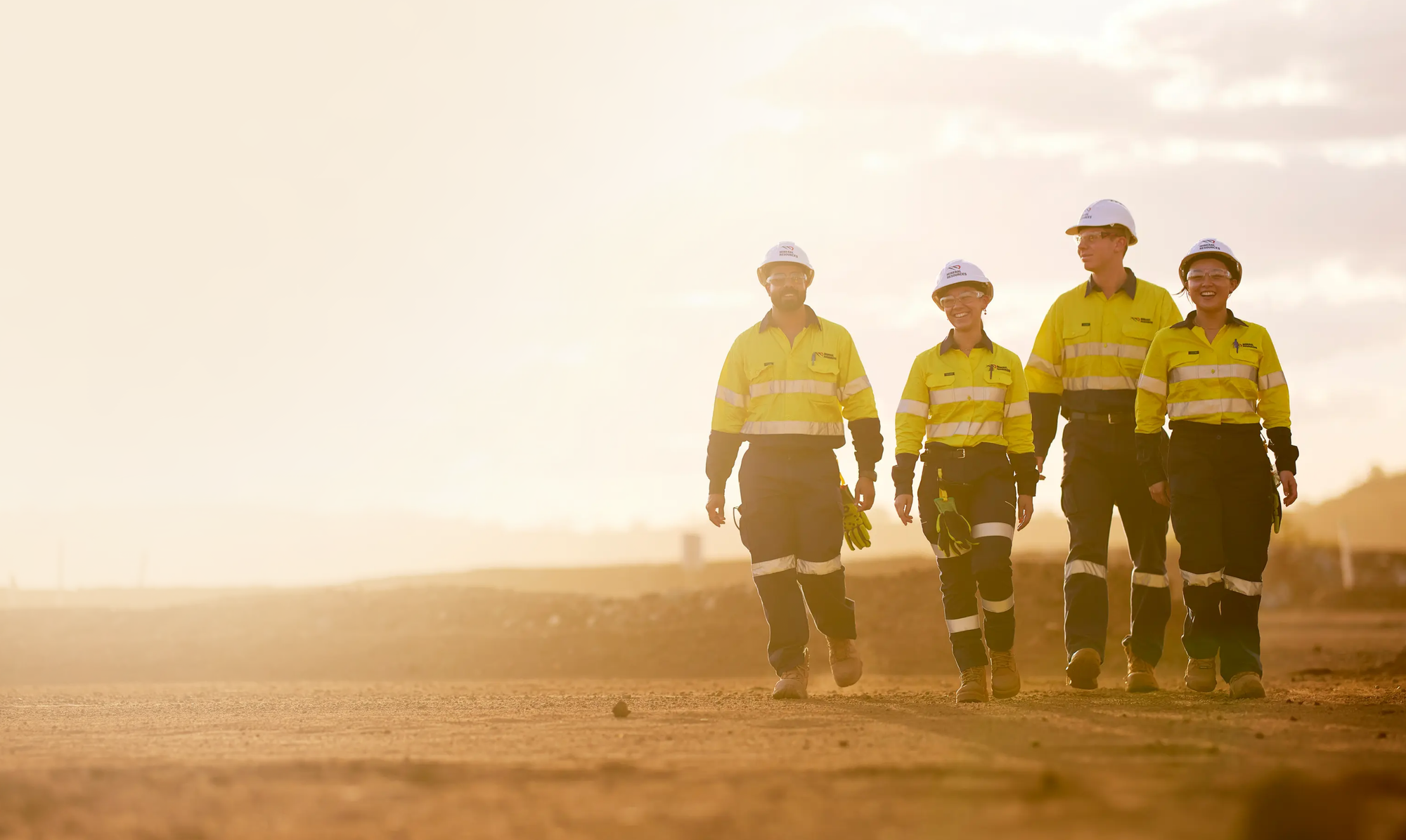 MinRes workers walking on dirt ground