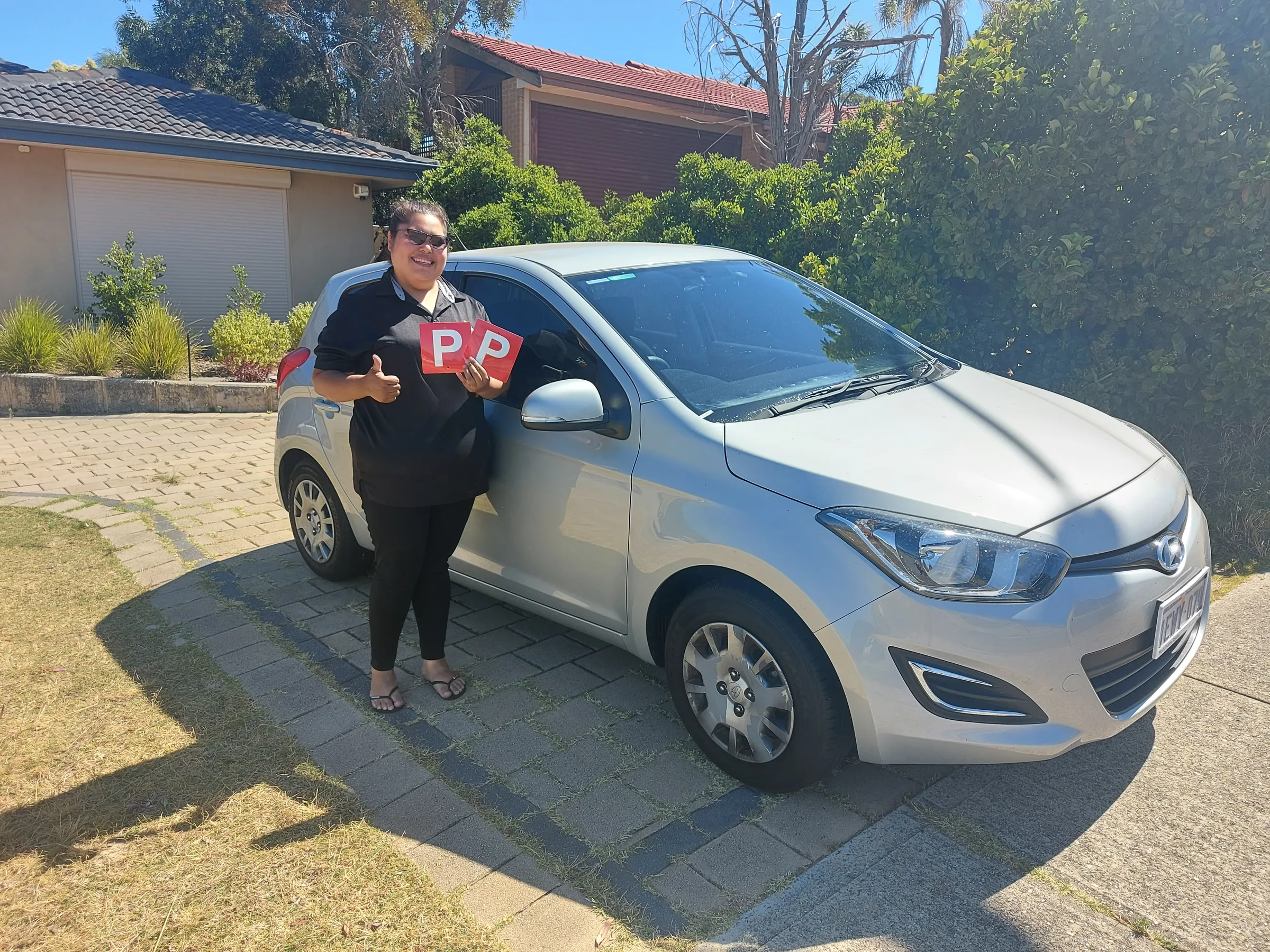 Ursula Lyndon in front of a car