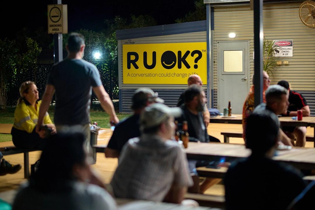 people sitting outside a mine village for R U OK day