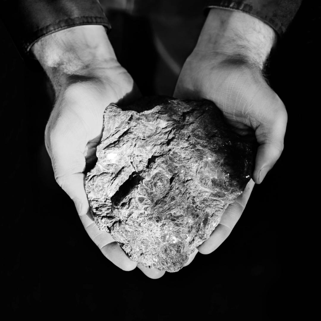 Hands holding a rock