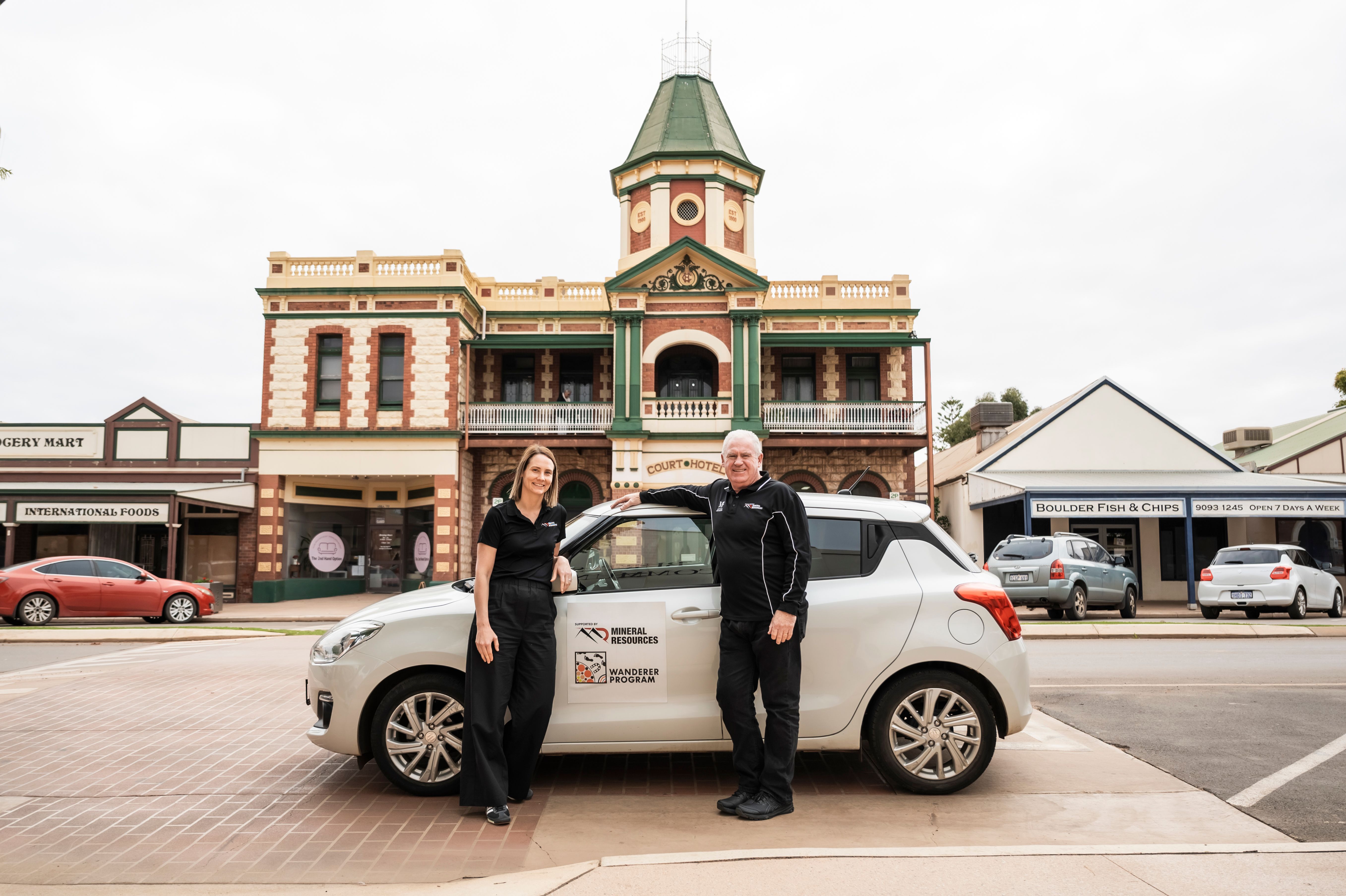 Man and woman standing in front of a car
