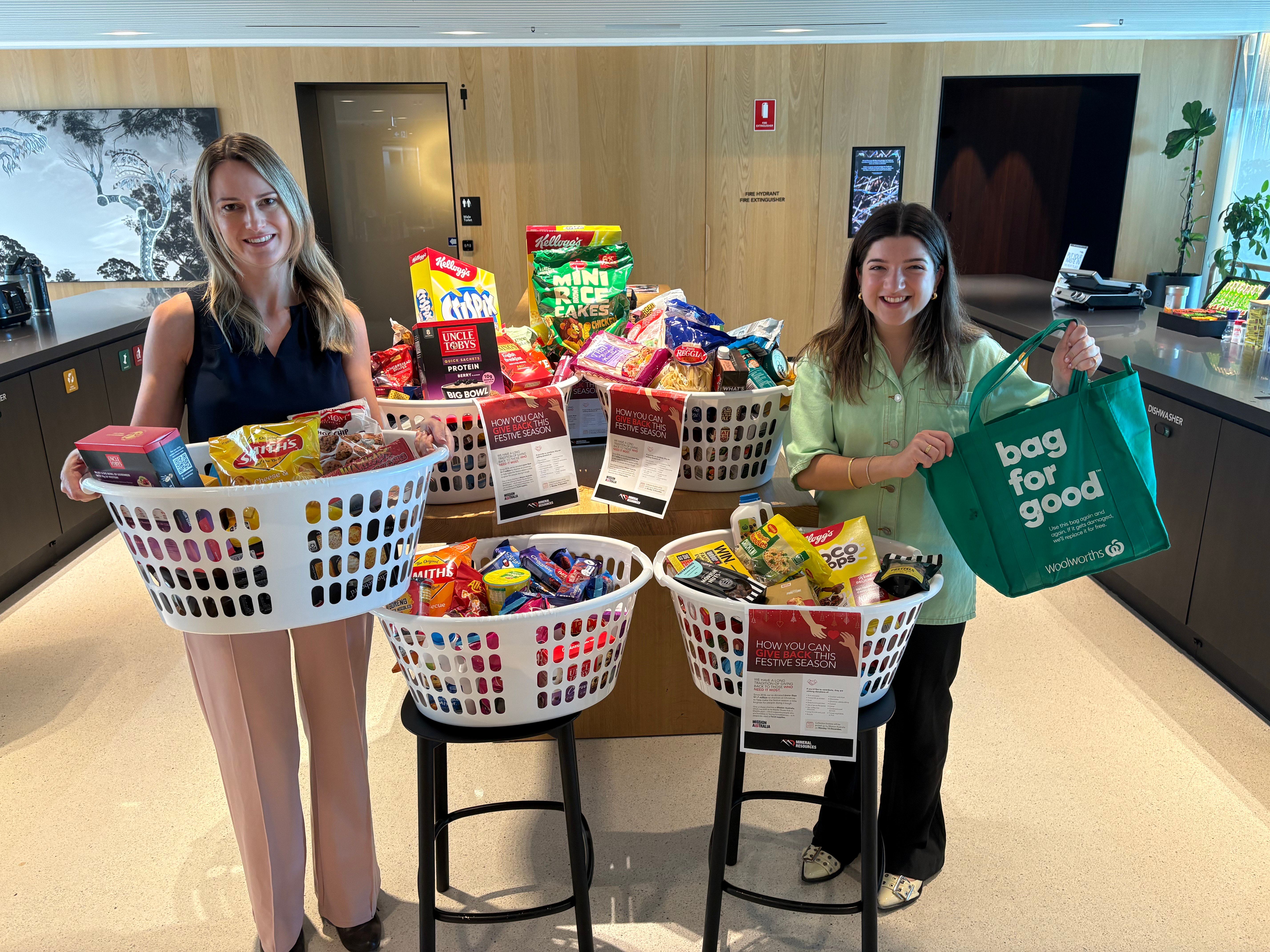 2 young women holding food donations for those in need 