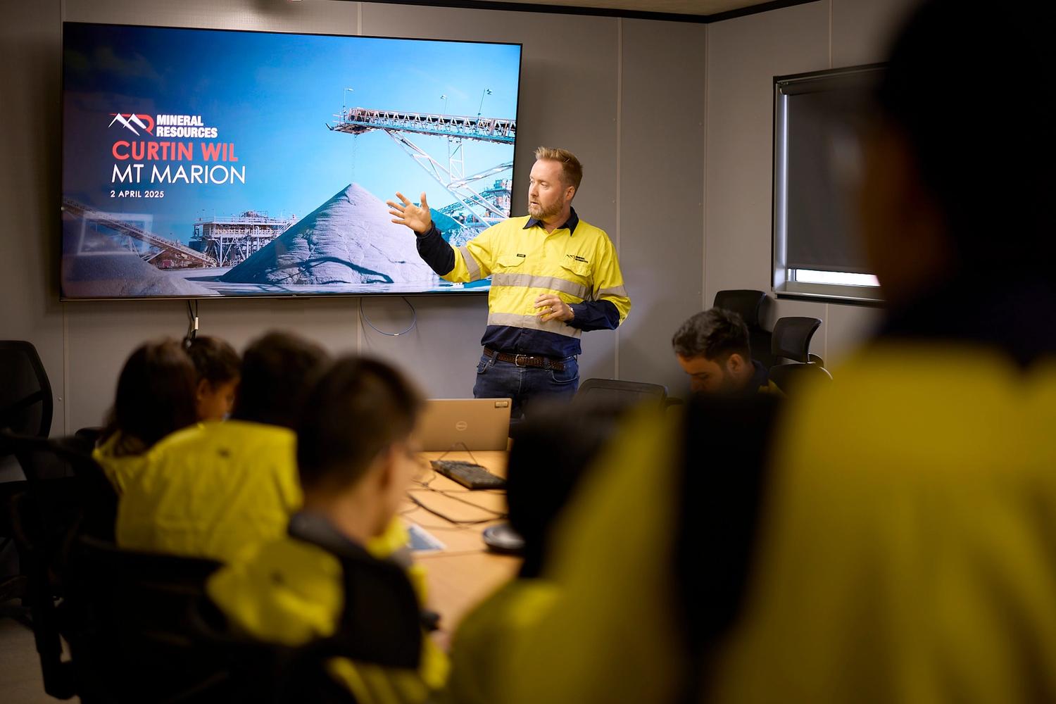 Man presenting to a group in an office