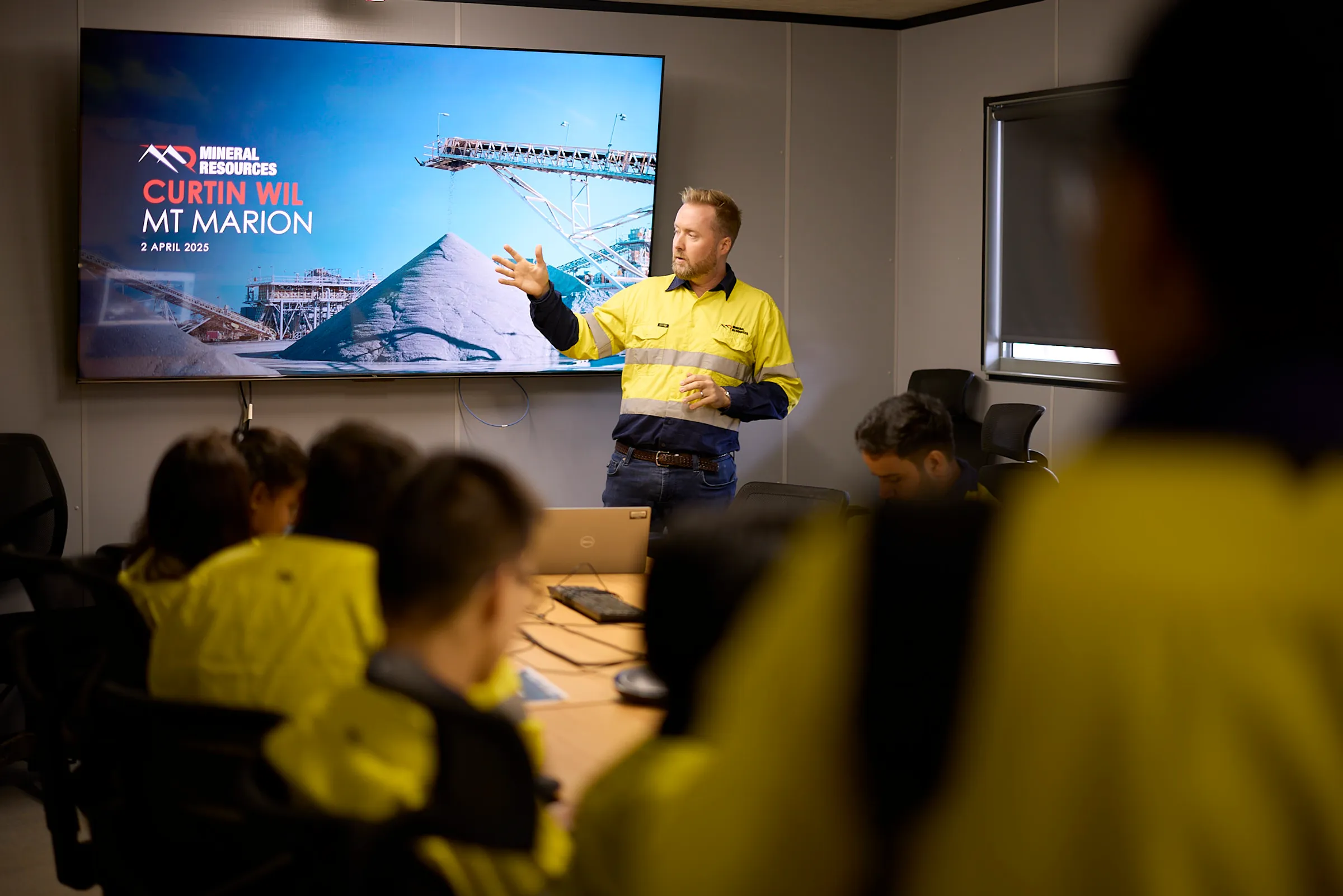 Man presenting to a group in an office