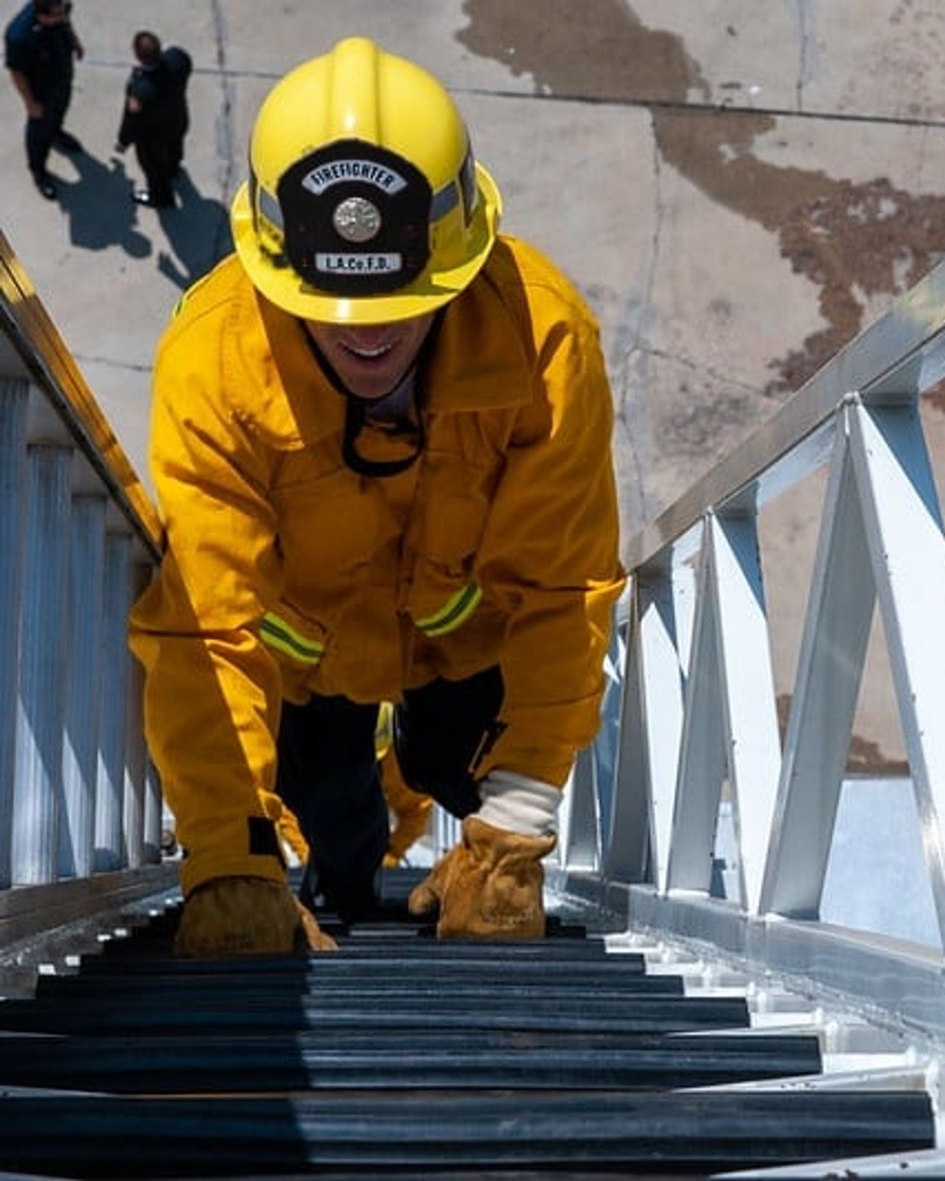 Firefighter climbing a ladder